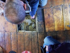 Marco lifts up the loose floorboards to reveal a 400 year old mummified cat - put there for good luck.